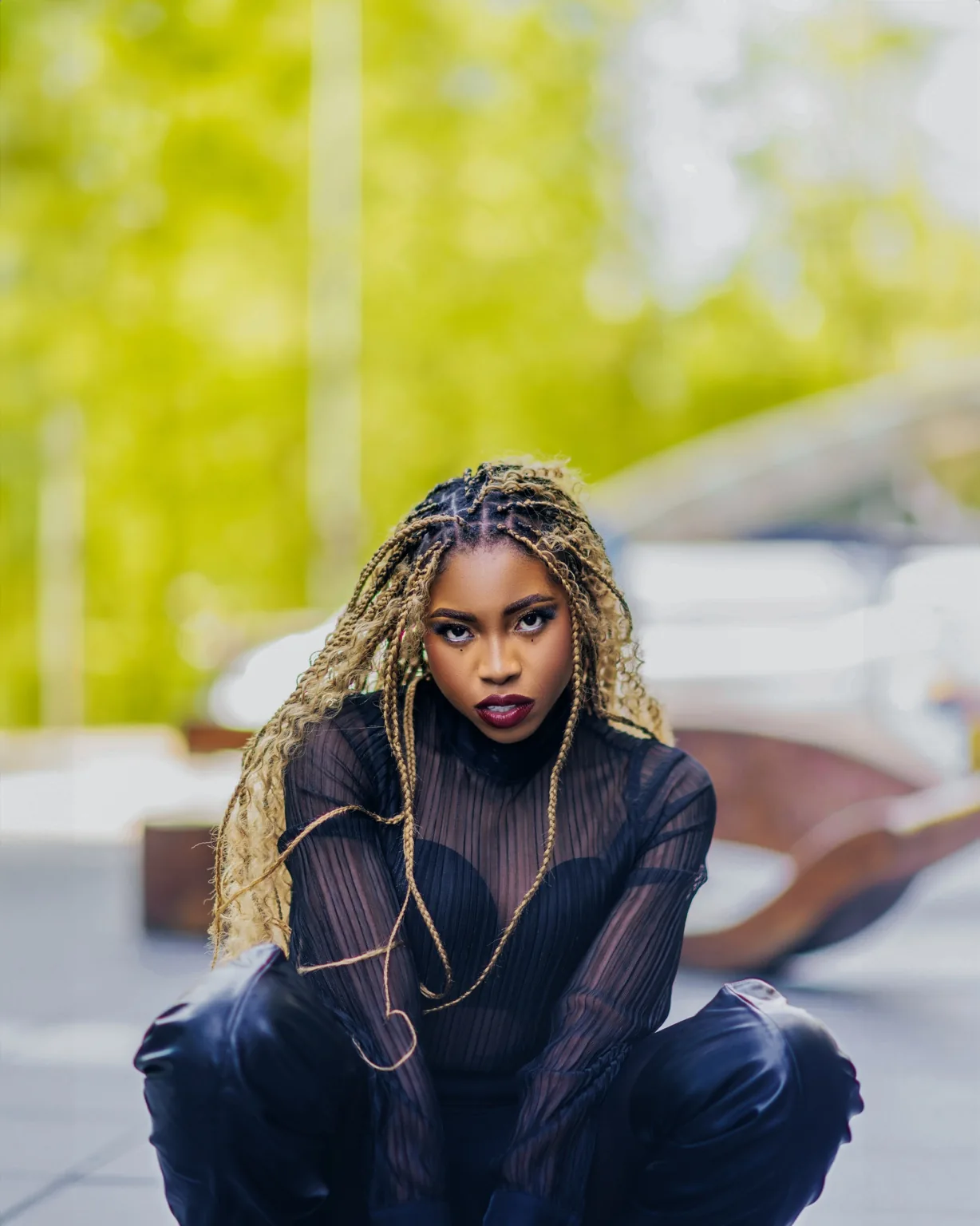 Ret Qut in a black outfit with blonde braids